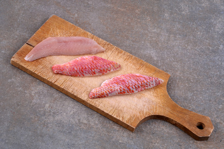 Fillets of red mullet on a cutting boardの写真素材