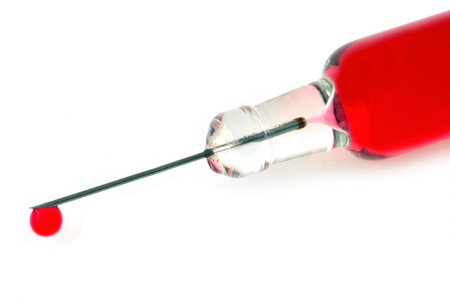 Drop of blood at the end of a syringe needleの写真素材