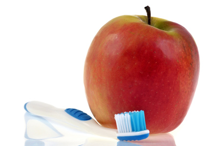 Apple and toothbrush  isolated on whiteの写真素材