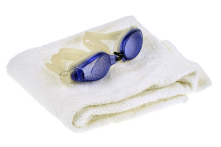 Diving glasses on a bath towelの写真素材