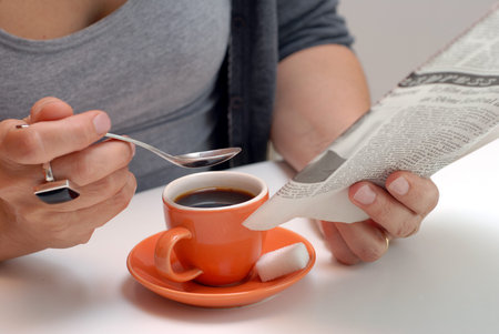 Read the newspaper while drinking a coffeeの写真素材