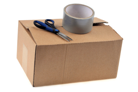 Adhesive and scissors on a cardboardの写真素材