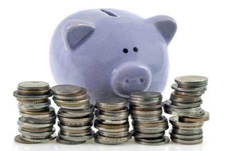 Piggy bank behind coinsの写真素材