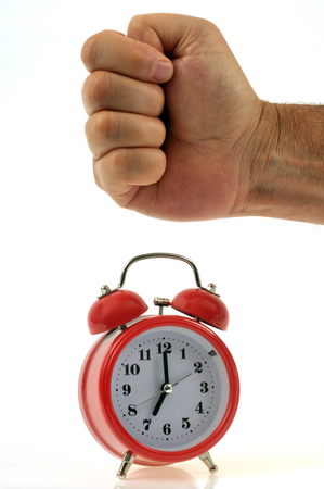 Fist on an alarm clockの写真素材