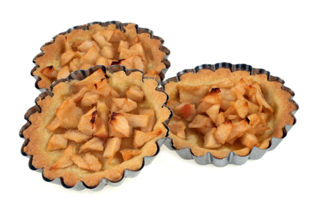 Three apple tartlets in their moldの写真素材