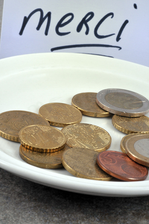 Coins in a saucer in close upの写真素材