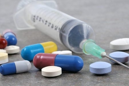 Syringe and drugs in close up