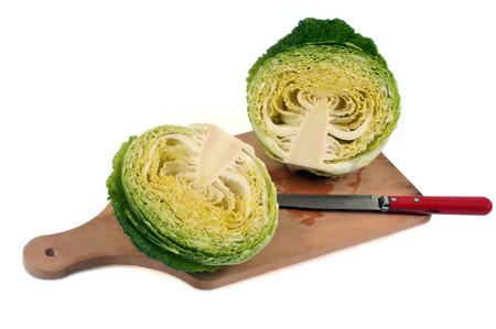 Cabbage cut in half on a cutting boardの写真素材