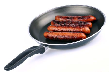 Sausages cooked in a pan on a white backgroundの写真素材