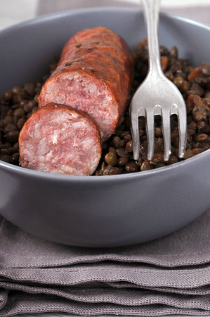 Plate of smoked sausage with lentils in close-upの写真素材