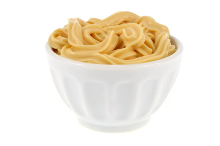 Bowl of mayonnaise on a white backgroundの写真素材