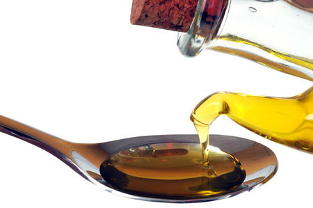 Pour oil into a spoon in close-upの写真素材