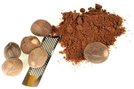 Nutmeg and nutmeg powder on white backgroundの写真素材