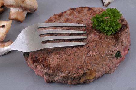Ground beef steak with parsley in close-up