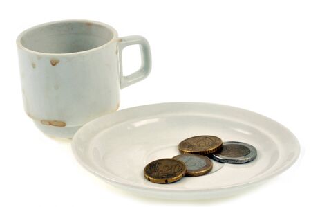 Tip and cup of empty and dirty coffee close-up on white backgroundの写真素材