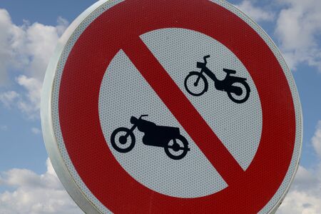 Road sign prohibiting the passage of motorcycles and mopedsの写真素材