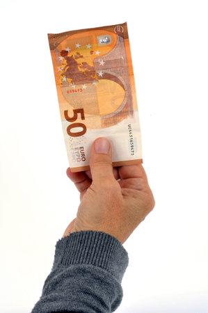 Fifty euro banknote in hand close up on white background