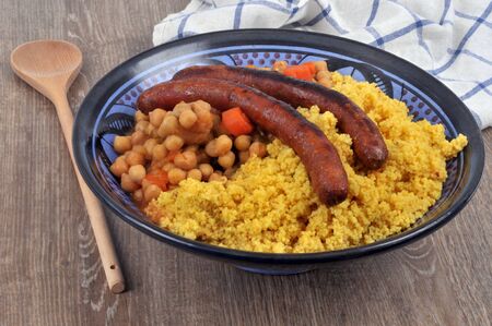 Couscous with vegetables and merguez served at the tableの写真素材