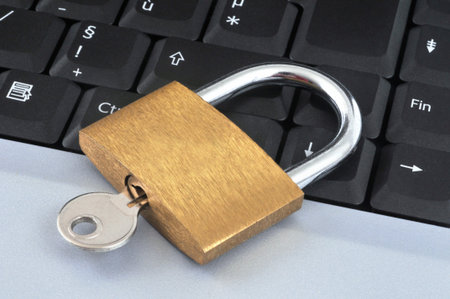 Computer security concept with a padlock on a laptop keyboard