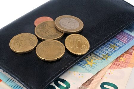Coins and banknotes on a close-up walletの写真素材