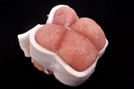 Raw veal paupiette close-up on black background