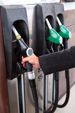 Hand taking gas oil gun close upの写真素材