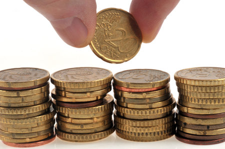 Savings concept with someone stacking coins on white background