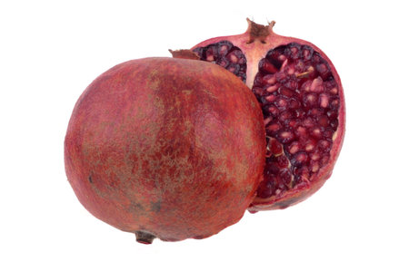 Pomegranate cut in half close up on white backgroundの写真素材
