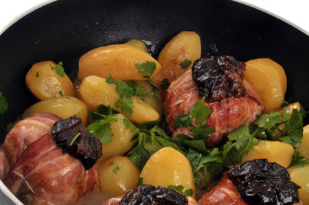 Rabbit paupiettes with prunes with potatoes in a pan close-upの写真素材