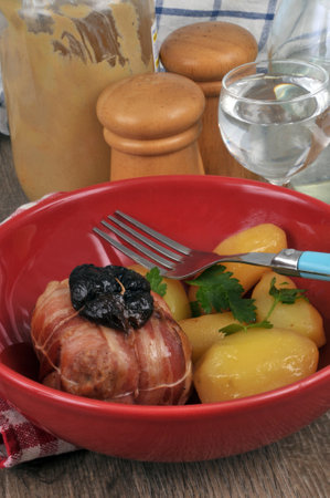 Rabbit paupiette with prunes with potatoes on a plateの写真素材