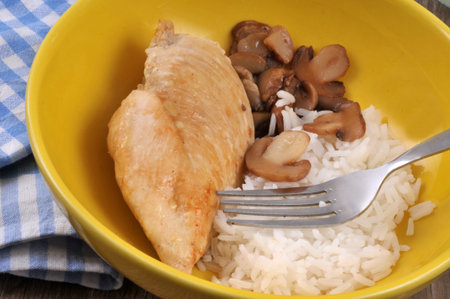 Chicken cutlet with rice and mushrooms served on a plate close-upの写真素材