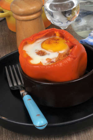 Pepper stuffed with a fried egg served in a ramekin close-upの写真素材