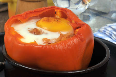 Pepper stuffed with a fried egg served in a ramekin close-upの写真素材