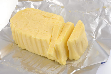 Sliced butter in its wrapping paper close-up