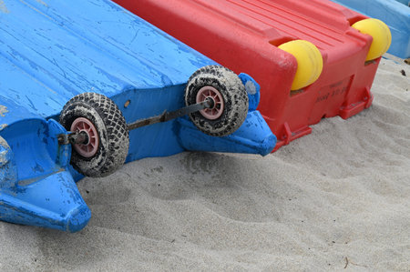 Close-up of boats overturned on the sand with wheels