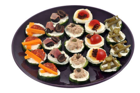 Assortment of cucumber appetizers in dish on white backgroundの写真素材