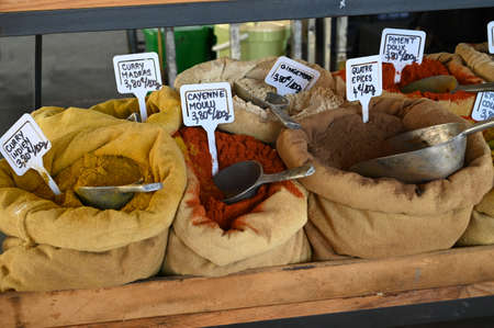 Bags of assorted spices on a market stallの写真素材