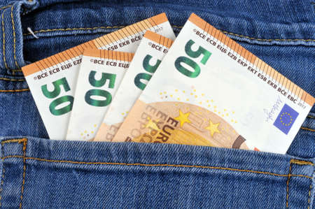 Fifty euro banknotes in a jeans pocket close-upの写真素材