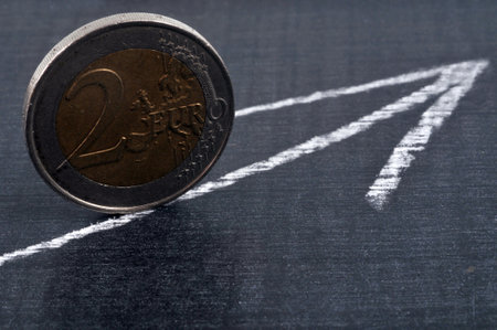 Profit concept with a two euro coin and an arrowの写真素材