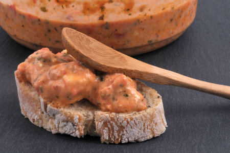 Toast of bread with ktipiti and a wooden spoon close-up