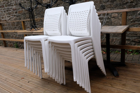 White plastic chairs of a stacked bar terraceの写真素材
