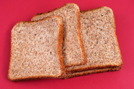 Slices of sandwich bread close-up on a red background
