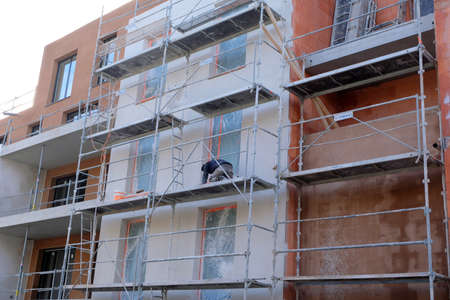 Worker on scaffolding at a construction siteのeditorial素材