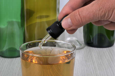 Concept of pouring GHB into a glass with a pipetteの写真素材