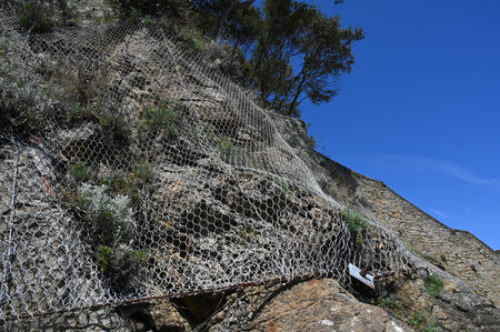 Security mesh to prevent rocks from falling on a rock wallの写真素材