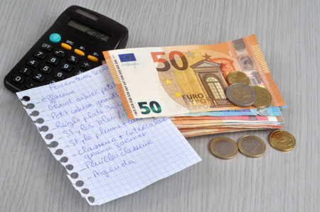 School supply list with a calculator and eurosの写真素材