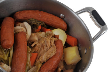 Cabbage hotpot in a Dutch oven close-up on a white backgroundの写真素材