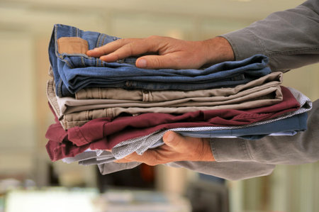 Pile of folded laundry in hand