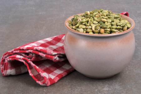 Container of raw chickpeas with a napkin close-up on a gray backgroundの写真素材
