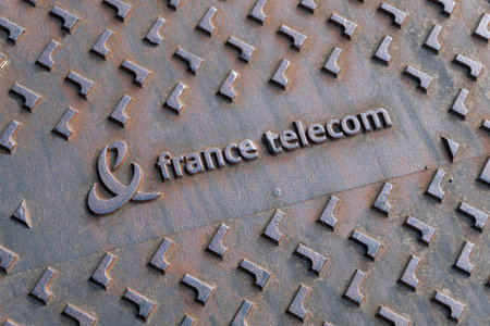 Cast iron street sign with France Telecom written on itのeditorial素材